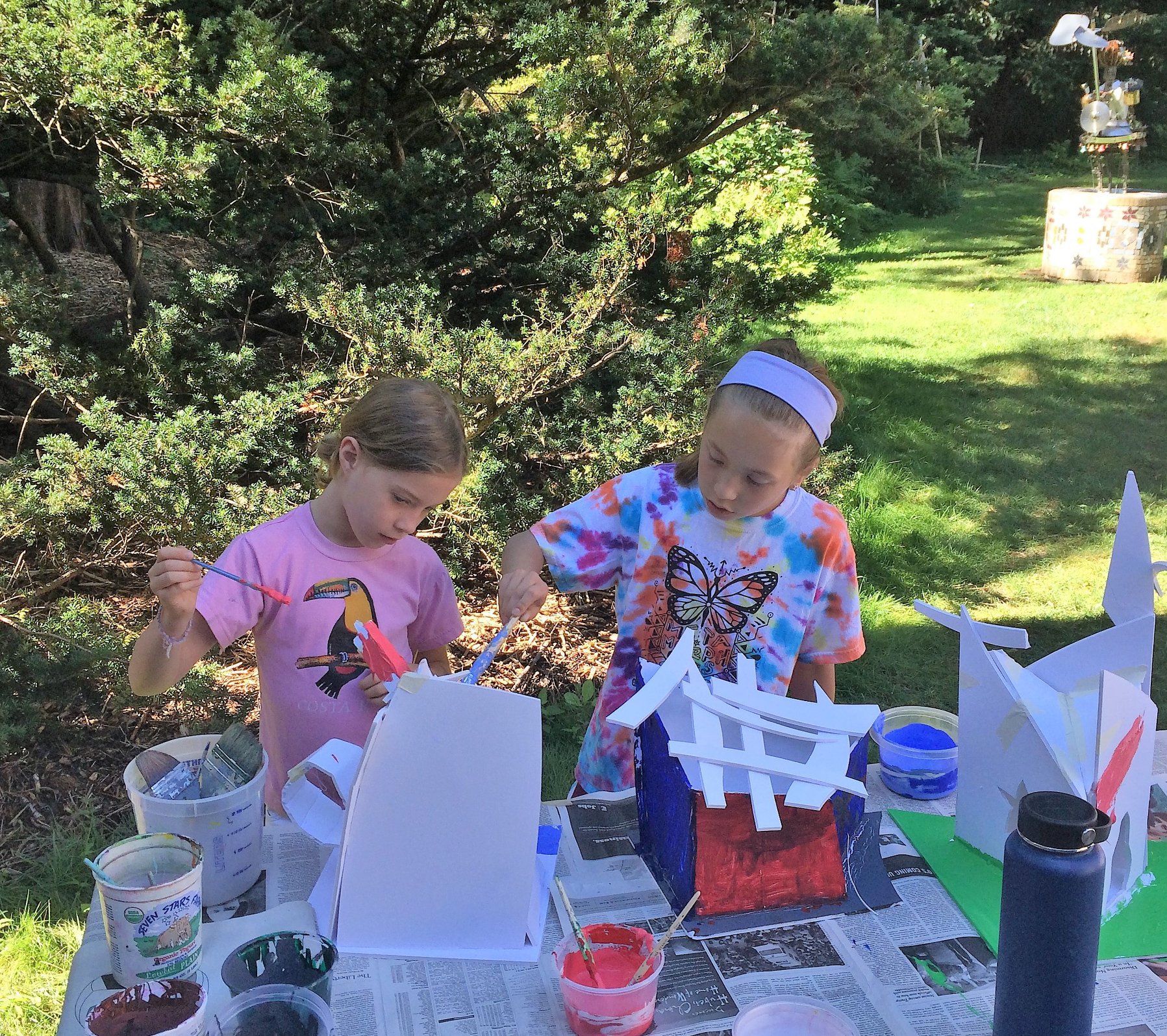 Two girls doing arts and crafts outside